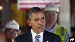 President Barack Obama speaks about jobs and the economy during a tour of an energy-efficient office building renovation near the White House in Washington, December 2, 2011.