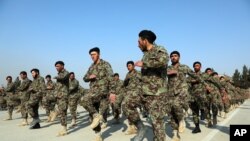 FILE - In this Jan. 18, 2021, photo, new Afghan National Army troops march during their graduation ceremony after a three-month training program at the Afghan Military Academy in Kabul, Afghanistan.