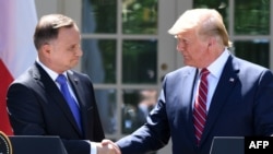 U.S. -- US President Donald Trump and Polish President Andrzej Duda shake hands after holding a joint press conference in the Rose Garden of the White House in Washington, DC, June 12, 2019.