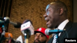 The elder Michael Brown watches attorney Benjamin Crump speak during a news conference in Ferguson, Missouri, Nov. 25, 2014.