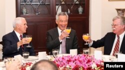 U.S. Vice President Mike Pence, left, and U.S. National security adviser John Bolton, right, attend a working breakfast hosted by Singaporean Prime Minister Lee Hsien Loong at the Istana, or Presidential Palace, in Singapore, Nov. 16, 2018.