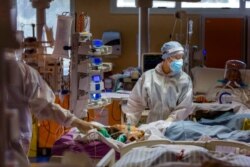 Medical staff of the intensive care unit of the Casalpalocco COVID-19 Clinic in the outskirts of Rome tend to patients, Oct. 21, 2020. (Associated Press)