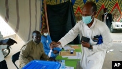 FILE - A man votes at a polling station in N'djamena, Chad, April 11, 2021. Chadian President Idriss Debi is seeking to extend his three-decade-long rule, running for a sixth time in this oil-producing Central African nation.