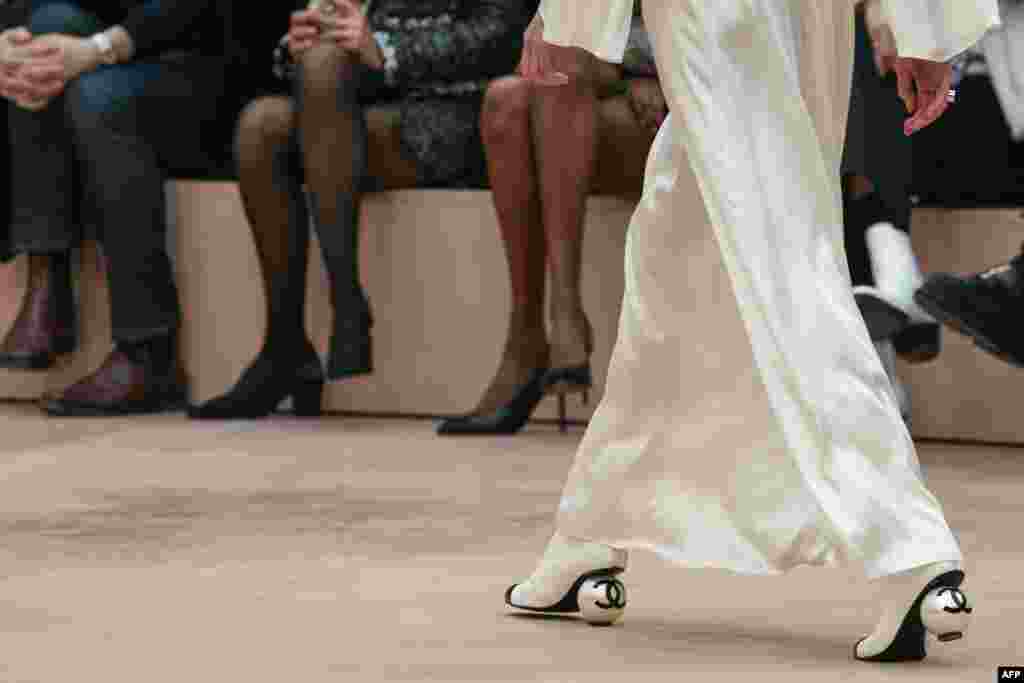 A model wears a pair of shoes during a presentation of creations by Chanel for the Womenswear Ready-to-wear Fall-Winter 2025/2026 collection as part of the Paris Fashion Week, at the Grand Palais, in Paris.