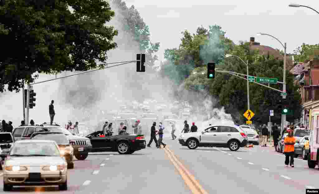 Tear gas rises as police attempt to disperse protesters on Page Avenue after a shooting incident in St. Louis, Aug. 19, 2015.&nbsp;