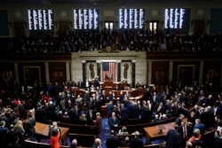 FILE - House members vote on article II of impeachment against President Donald Trump as House Speaker Nancy Pelosi of California stands on the dais on Capitol Hill in Washington, Dec. 18, 2019.
