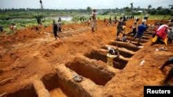 Workers are digging graves for mudslide victims at the Paloko cemetery in Waterloo, Sierra Leone, Aug. 17, 2017.