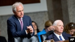 FILE - Chairman Sen. Bob Corker, left, and Ranking Member Sen. Ben Cardin, right, are seen hearing testimony during a Senate Foreign Relations Committee hearing on Capitol Hill, in Washington, July 23, 2015.