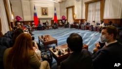 U.S. Representative Mark Takano, D-Calif. center left chats with Taiwanese President Tsai Ing-wen near other members of the U.S. delegation at the Presidential Office in Taipei, Taiwan, Nov. 26, 2021.