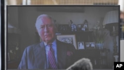 A view of Britain's Prince Charles projected on a screen to delivering a video message from his residence in Scotland, during the opening of the NHS Nightingale Hospital in London, April 3, 2020.