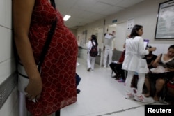 FILE - Pregnant woman waits for a routine general checkup, which includes Zika screening, at the maternity ward of the Hospital Escuela in Tegucigalpa, Honduras, Jan. 27, 2016.