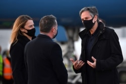 Yael Lempert, Charge d'Affaires of the US embassy, left, and John Holloway, UK representative from the Foreign and Commonwealth Office greet US Secretary of State Antony Blinken, right, in northeast of London on May 2, 2021.