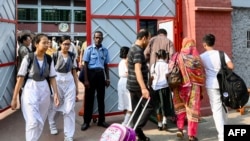 Students arrive to attend classes on a hot summer day, at a school in Dhaka on April 28, 2024, amid the ongoing heatwave.