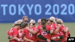 Canada's softball players gather after losing the game during the Tokyo 2020 Olympic Games softball opening round game between USA and Canada at Fukushima Azuma Baseball Stadium in Fukushima, Japan, on July 22, 2021. 