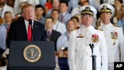 President Donald Trump, left, puts the USS Gerald Ford into commission as Navy commanders look on, at Naval Station Norfolk, in Norfolk, Virginia, July 22, 2017.
