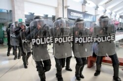 FILE - Riot police prepare to disperse protesters during a rally against Nicaraguan President Daniel Ortega's government in Managua, Nicaragua, Feb. 25, 2020.