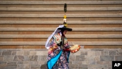 A Buddhist monk performs a traditional dance as part of the rituals during Gyalpo Losar, the Sherpa community&#39;s New Year celebration, at Shechen Monastery in Kathmandu, Nepal.