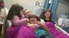 Joyce Sasser enjoys a 2016 hospital visit from her grandchildren. Today, she is out of the hospital and in good health. (Photo courtesy: Joyce Sasser)