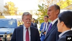U.S. National Security Adviser John Bolton, left, and Russian Security Council chairman Nikolai Patrushev talk prior their official talks in Moscow, Russia, Oct. 22, 2018. 