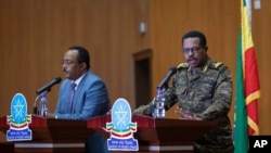 Lt. Gen. Bacha Debele of the Ethiopian National Defense Force, right, gives a press conference with Redwan Hussein, spokesperson for the Tigray task force, about the situation in the country's Tigray region, in Addis Ababa, Ethiopia, June 30, 2021.