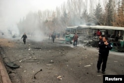 People react to an explosion that ripped apart a bus, in Kayseri, Turkey, Dec. 17, 2016.
