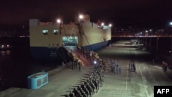 FILE - This screen grab taken from video released on August 29, 2019 from China's state-run CCTV shows People's Liberation Army (PLA) troops for the Hong Kong Garrison arriving on a ship in Hong Kong during a routine rotation of personnel. 