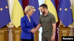 FILE - Ukraine's President Volodymyr Zelenskyy and European Commission President Ursula von der Leyen shake hands before meeting, as Russia's invasion of Ukraine continues, in Kyiv, Ukraine, Sept. 15, 2022. 