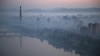 Dawn breaks over Pyongyang, North Korea, as buildings poke through the midst and the Juche Tower, left, stands by the Taedong riverbank, Oct. 13, 2015.