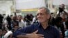 FILE - Iranian President-elect Masoud Pezeshkian greets supporters a day after the presidential election, at the shrine of the late revolutionary founder Ayatollah Khomeini, just outside Tehran, Iran, July 6, 2024.