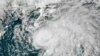 FILE - This July 6, 2021 satellite image shows Tropical Storm Elsa in the Gulf of Mexico off the coast of Florida. NOAA updated its outlook for the 2021 Atlantic season, slightly increasing the expected number of named storms and hurricanes. 