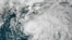 FILE - This July 6, 2021 satellite image shows Tropical Storm Elsa in the Gulf of Mexico off the coast of Florida. NOAA updated its outlook for the 2021 Atlantic season, slightly increasing the expected number of named storms and hurricanes. 
