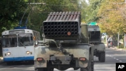 Pro-Russian rebels drive Grad multiple rocket launchers in the town of Donetsk, Ukraine, Sept. 11, 2014. The European Union on Tuesday condemned recent clashes in eastern Ukraine between pro-Russian rebels and government forces, calling the fighting a “blatant violation” of the Minsk truce.