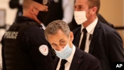 Former French President Nicolas Sarkozy arrives at the courtroom, Nov. 23, 2020 in Paris. 