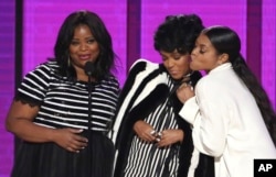FILE - Octavia Spencer, from left, Janelle Monae and Taraji P. Henson of the film “Hidden Figures,” present an award at the American Music Awards in Los Angeles, Nov. 20, 2016.