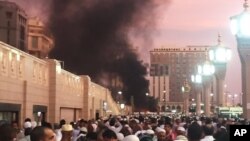 People stand by an explosion site in Medina, Saudi Arabia, July 4, 2016. (Courtesy of Noor Punasiya via AP)