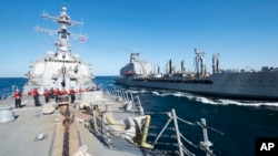 FILE - U.S. Navy, guided-missile destroyer USS Bulkeley participates in a replenishment-at-sea with fleet replenishment oiler USNS John Lenthall in the Gulf of Oman.