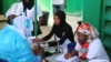 Women sign up for free breast and cervical cancer screenings organized by nonprofit Junior Chamber International at the Philippe Maguilen Senghor health center in Yoff, Dakar, Senegal, April 22, 2017. (S. Christensen/VOA)