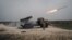 FILE - A rocket is fired from a rocket launcher outside Makhmour, about 75 km (47 miles) east of Mosul, Iraq, March 25, 2016.