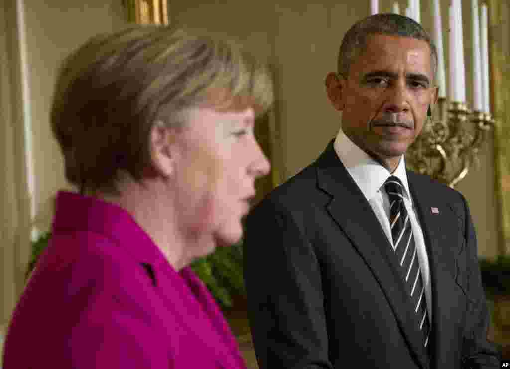 President Barack Obama listens as German Chancellor Angela Merkel speaks during their joint news conference in the East Room of the White House in Washington, Feb. 9, 2015.