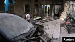 Medics inspect the damage outside a field hospital after an airstrike in the rebel-held al-Maadi neighbourhood of Aleppo, Syria, Sept. 28, 2016. 