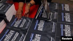 U.S. Government Publishing Office employee Darlene Matthews arranges new copies of President Donald Trump's Budget for the U.S. Government for the Fiscal Year 2019 at the U.S. Government Publishing Office in Washington, Feb. 12, 2018.