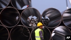 FILE - Pipes are stacked up to be used for the Trans-Adriatic Pipeline project in Durres, Albania, April 18, 2016, to transport gas from the Shah Deniz II field in Azerbaijan, across Turkey, Greece, Albania and undersea into southern Italy.