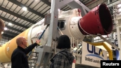 United Launch Alliance systems test engineer Dane Drefke points to a Delta IV rocket at the Horizontal Integration Facility at Cape Canaveral Air Force Station in Florida, U.S., January 15, 2019. (REUTERS/Eric Johnson)