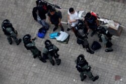 Riot police officers detain anti-government protesters in Wan Chai district, Hong Kong, Sept. 29, 2019.