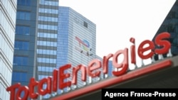 FILE - This May 28, 2021, photo shows the new TotalEnergies logo during its unveiling ceremony, at a charging station in La Defense on the outskirts of Paris.