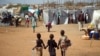 Three children walk through a camp for internally displaced persons at the United Nations Mission to South Sudan (UNMISS) base in Juba, Jan. 9, 2014.