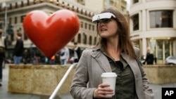 Yvonne Felix wears eSight electronic glasses and looks around Union Square during a visit to San Francisco, Feb. 2, 2017. The glasses enable the legally blind to see. Felix was diagnosed with Stargardt's disease after being hit by a car at age 7.