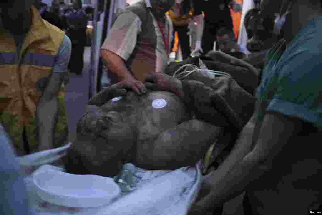 An injured miner is carried into a hospital in Soma, western Turkey, May 13, 2014.