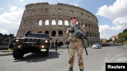 FILE - A soldier patrols in front of the Colosseum in Rome, Apr. 14, 2017. Italian army will start guarding medical staff at a hospital in the southern Calabria region from Monday, after a string of violent attacks on doctors and nurses.