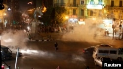 Tear gas fired by riot police at protesters fill the air during clashes at Talaat Harab square in downtown Cairo, Nov. 26, 2013.